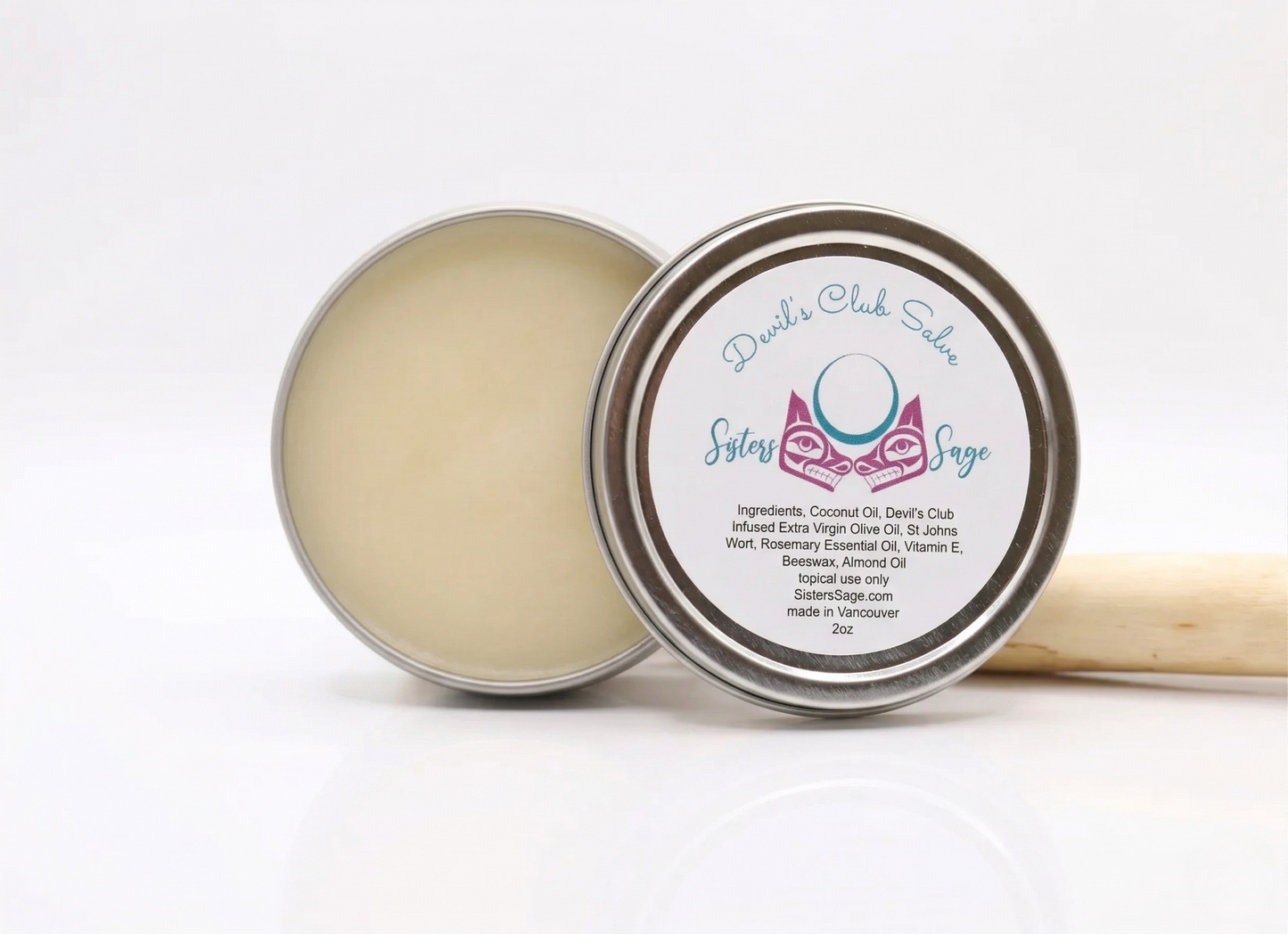 Devils club salve in a metal tin, devils club stick behind tin