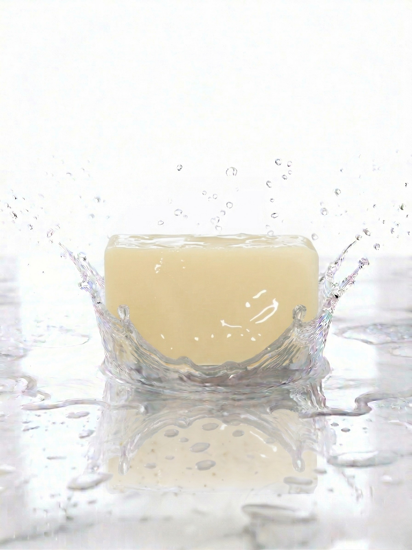 Bar of soap with water droplets on a white background