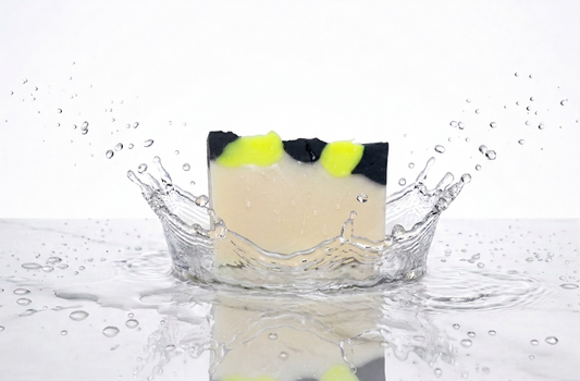 Black and neon green topped soap in a water splash