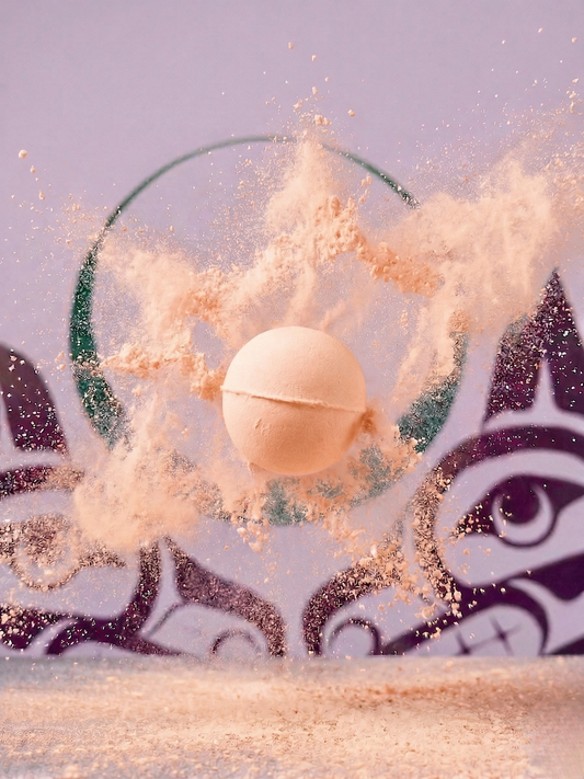 Peach coloured bath fizzie and sisters sage logo in the background