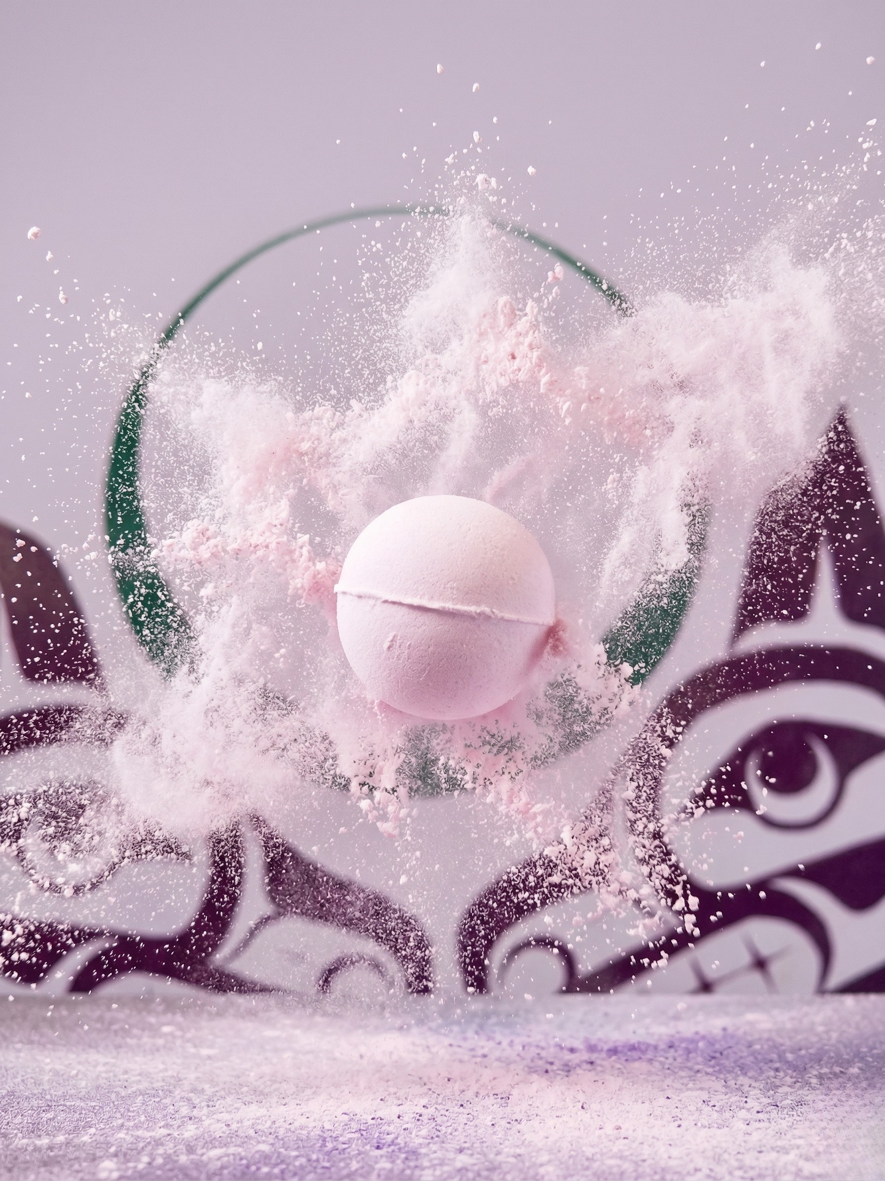 Pink bath fizzie with bath fizzie poofing around, sisters lsage logo in the background