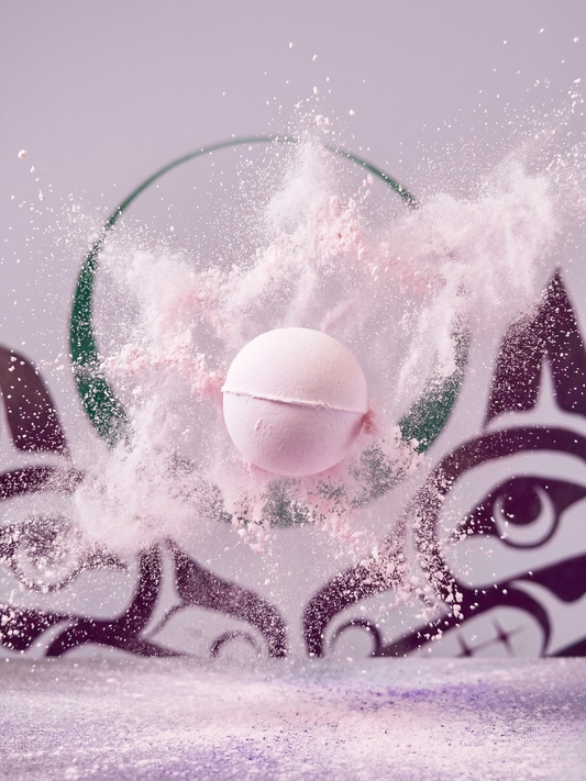 Pink bath fizzie with bath fizzie poofing around, sisters lsage logo in the background